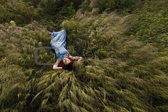 Beautiful woman sleeping on tall grass