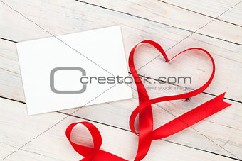 Photo frame or greeting card and valentines heart shaped ribbon