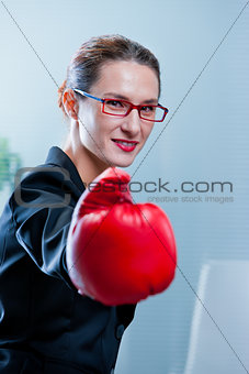 winning business woman with a red box glove