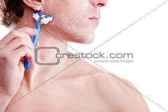 young man shaving with a blue razor