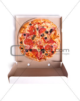 Delicious pizza with ham and tomatoes in box 