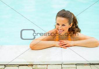Portrait of happy young woman in pool looking on copy space