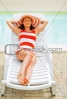 Relaxed young woman laying on sunbed