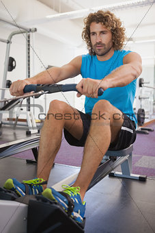 Handsome man using resistance band in gym