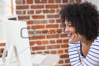 Female photo editor using computer in office