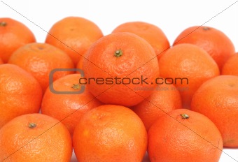 A lot of ripe tasty a tangerine on a white background