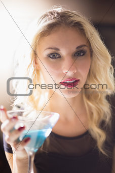 Attractive blonde drinking a cocktail