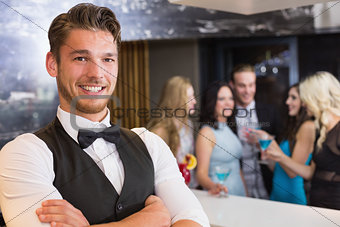 Handsome barman smiling at camera