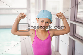 Cute little girl flexing her arms