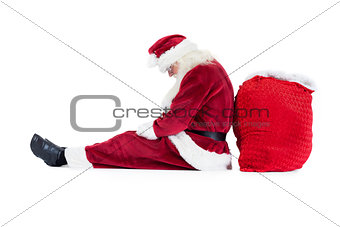 Santa sits leaned on his bag
