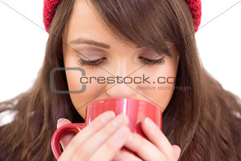 Close up of a festive brunette drinking from mug