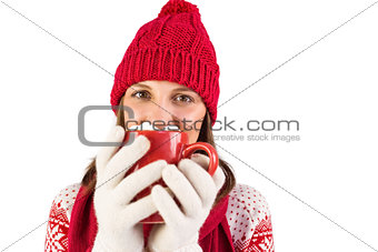 Happy brunette in winter clothes holding mug