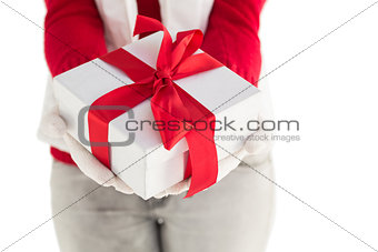 Woman in winter clothes offering a gift