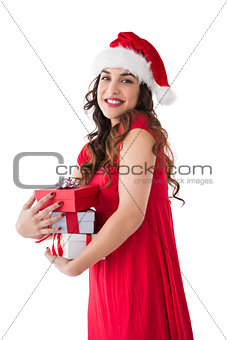 Festive brunette holding pile of presents