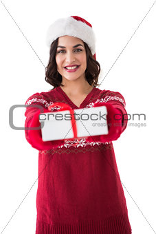 Smiling brunette in red gloves holding gift