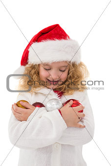 Festive little girl holding baubles