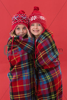 Festive little girls under a blanket
