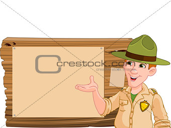 Ranger pointing at a wooden sign
