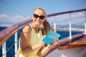 Happy woman with pad during sea traveling