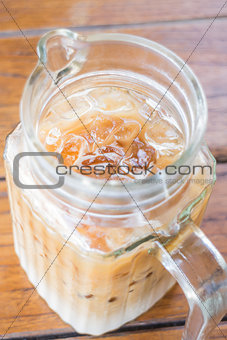 Close up iced coffee latte in glass pitcher 