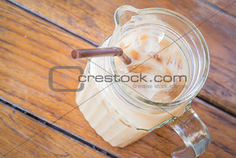 Close up fresh iced coffee latte in glass pitcher