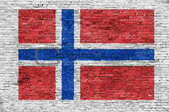 Norwegian flag over brick wall
