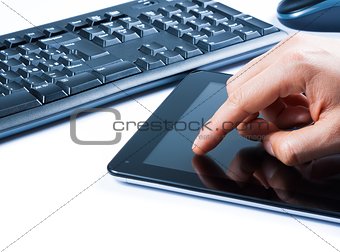 hand touching tablet near keyboard, concept of new technology