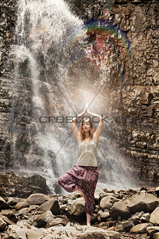 Yoga exercise on the waterfall background