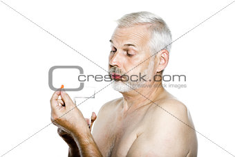 Senior man portrait taking medecine capsule