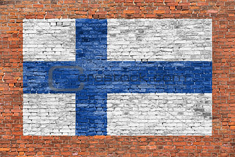National flag of Finland painted over brick wall