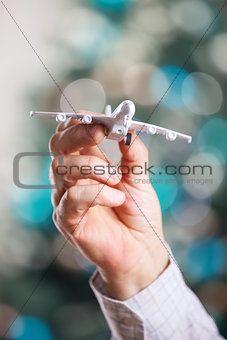 Closeup of man hand holding model of airplane