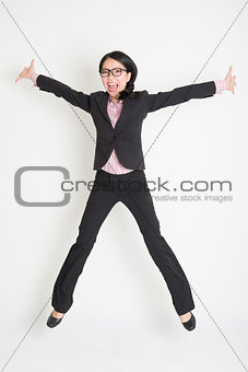 Business woman leaping high in the air