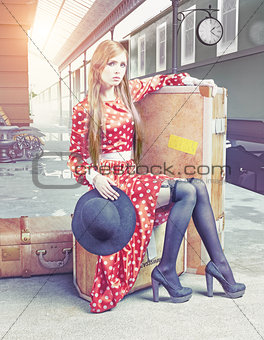 The girl  at the retro railway station 