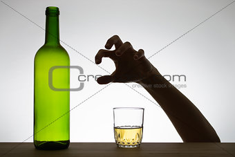 Hand reaching for a glass of wine