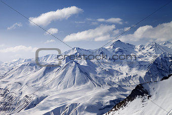 Snowy winter mountains in sun day