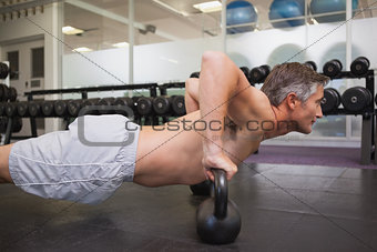Fit man using kettlebells in his workout