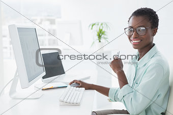 Happy businesswoman working at desk