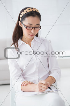 Businesswoman sitting and taking notes