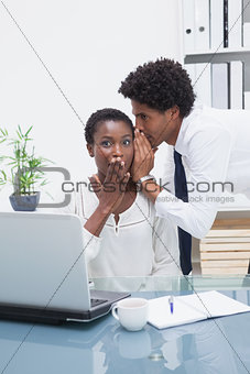 Man telling a business secret at his colleague