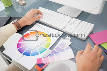 Designer using computer and colour wheel