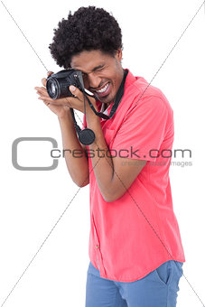 Happy man taking photograph with digital camera