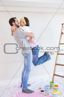 Cute couple hugging while redecorating