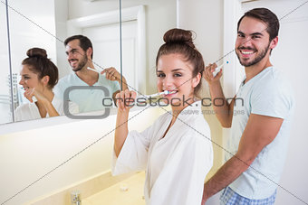 Young couple brushing their teeth