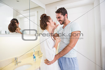 Young man putting cream on girlfriends nose