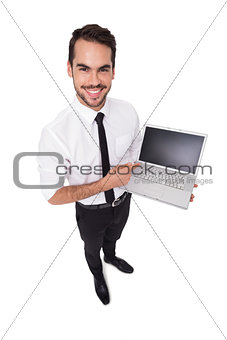 Smiling businessman pointing his laptop
