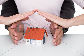 Casual couple sheltering small house
