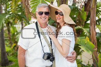 Holidaying couple smiling at camera
