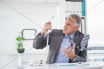 Angry businessman shouting on the phone