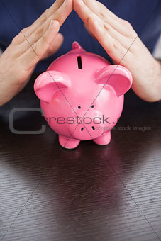 Young man with piggy bank
