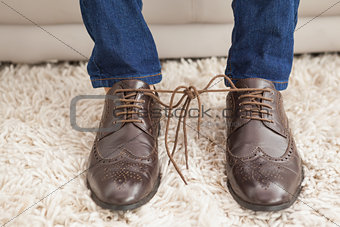 Classy mans shoelaces tied together